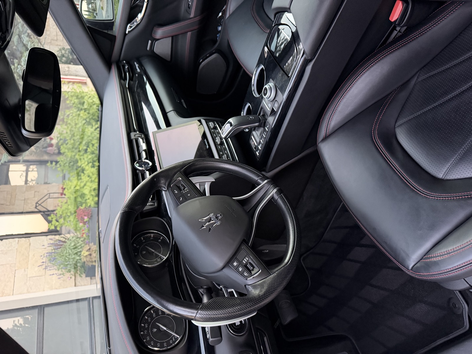 Maserati dashboard and black leather seats after an interior detail